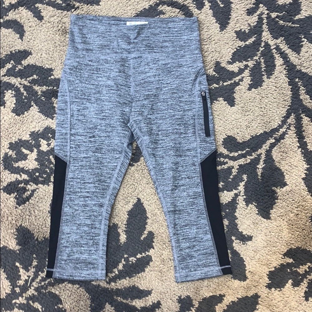 Gray leggings with black detailing and zipper